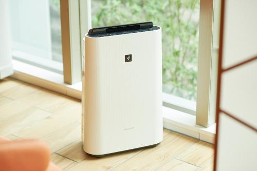 a white refrigerator sitting on a floor next to a window at Sotetsu Fresa Inn Daimon in Tokyo