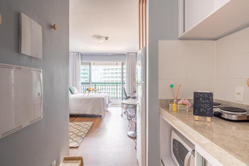 a kitchen with a counter and a dining room at BSB Stay Flats Particulares - SHN in Brasilia