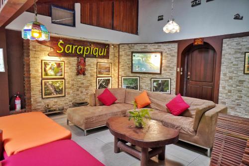 a living room filled with furniture and decor at La Quinta Sarapiqui Lodge in Sarapiquí
