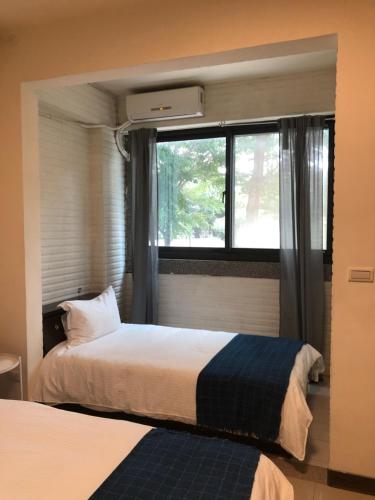 Postel nebo postele na pokoji v ubytování Yi Jia Homestay