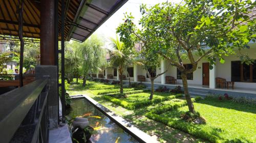 a garden in a building with a koi pond at Adil Villa & Resort in Ubud