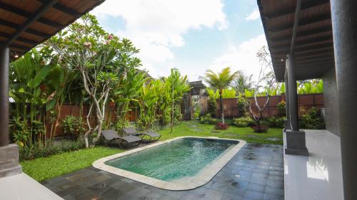 a swimming pool in the yard of a house at Adil Villa & Resort in Ubud