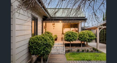 a house with a front door and some bushes at The Weeping Elm - Large and Spacious in Albury
