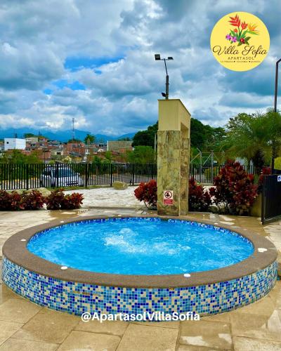 a small pool with a fountain in a yard at Apartasol Villa Sofia, Reserva de la Colina, La Tebaida, Quindio in La Tebaida