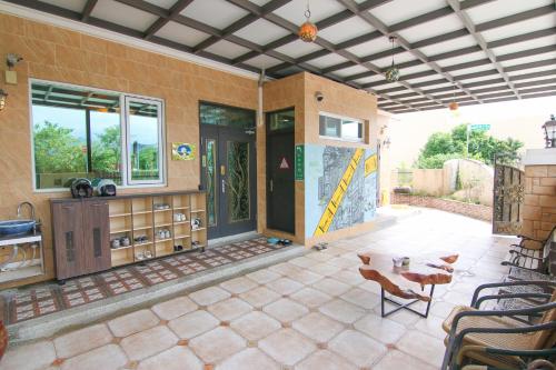 a patio with a table and chairs and a building at Corner No50 Hostel in Taitung City