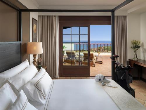 a bedroom with a bed with a view of the beach at Hotel Hacienda del Conde Meliá Collection Golf & Spa - Adults Only in Buenavista del Norte