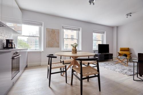a kitchen and dining room with a table and chairs at 5VH Virginia House, 31 Bloomsbury Way in London