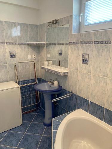 a bathroom with a sink and a bath tub at U poľovníka in Levoča