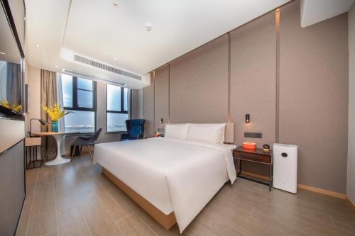 Atour Hotel Wuhan Jinyin Lakeにあるベッド