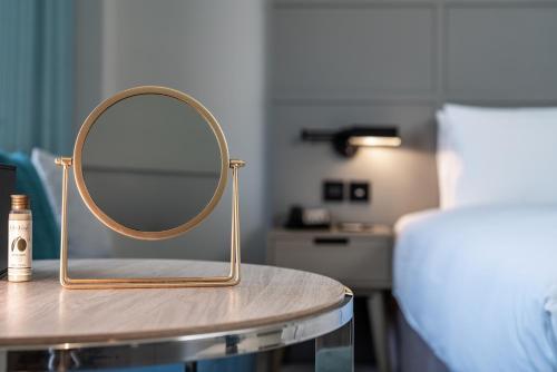 a mirror on a table in a room at Greet Inn in Kaohsiung
