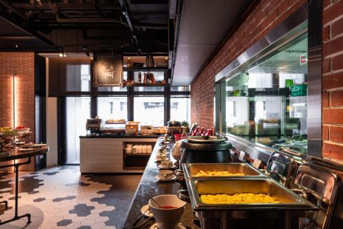 a kitchen with a long counter in a restaurant at Greet Inn in Kaohsiung