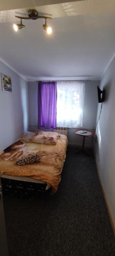 a bedroom with a large bed and a window at Zajazd pod Lwem in Trzebnica