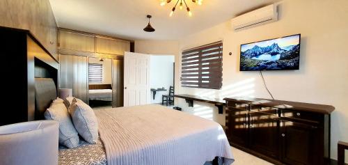 a bedroom with a bed and a desk in it at Solana Corpus Christi - Cozumel in Cozumel