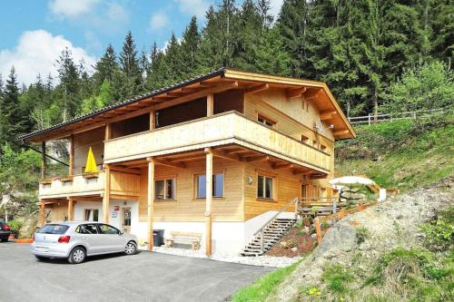 a house with a car parked in front of it at Chalet in Zell am Ziller near Ski Lifts in Zell am Ziller