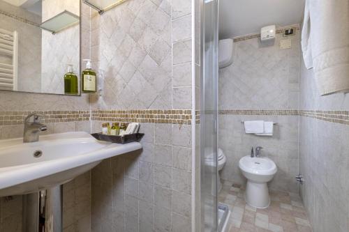 a bathroom with a sink and a toilet at Borgo Grondaie in Siena