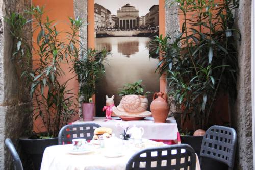 a table with a white tablecloth and chairs in a patio at Albergo Al Viale in Trieste