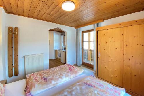 A bed or beds in a room at Apartment in Filzmoos with a balcony