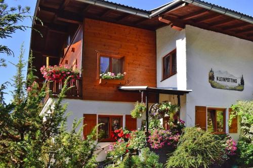 a house with flowers in front of it at Apartment in Hüttau near Ski Amadé Slopes in Hüttau