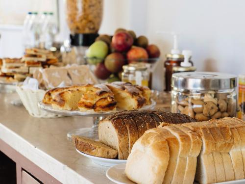 a table topped with lots of different types of bread at Hôtel Les 2 Alpes L'Orée Des Pistes in Les Deux Alpes