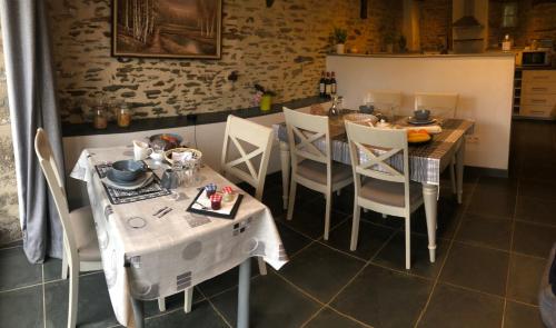 a dining room table and chairs in a room at Maison De Vacances A Brambuan in Josselin