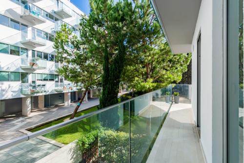 - un balcon avec vue sur une maison arborée dans l'établissement Oeiras Elegant Retreat with Pool, à Oeiras