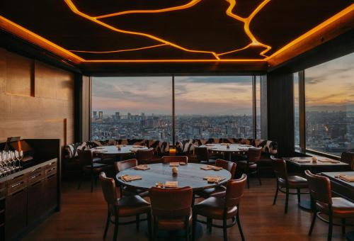 a restaurant with tables and chairs and a view at Nobu Hotel Barcelona in Barcelona
