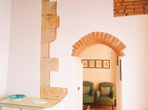 een boog in een woonkamer met een bank bij Ancient House in the Historic Center of Sarteano in Sarteano