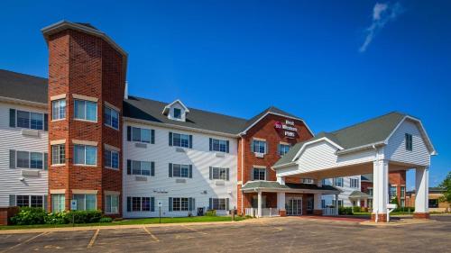 a large apartment building with a brick chimney at Best Western Plus Appleton Airport Mall Hotel in Appleton