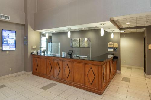 a hair salon with a large wooden reception desk at Best Western Coyote Point Inn in San Mateo
