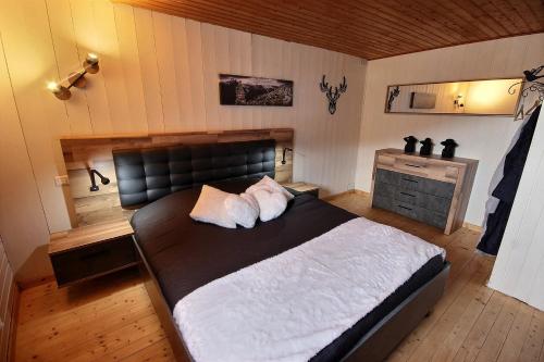 a bedroom with a large bed with two pillows at Spa et romance à Molliebon in Séez