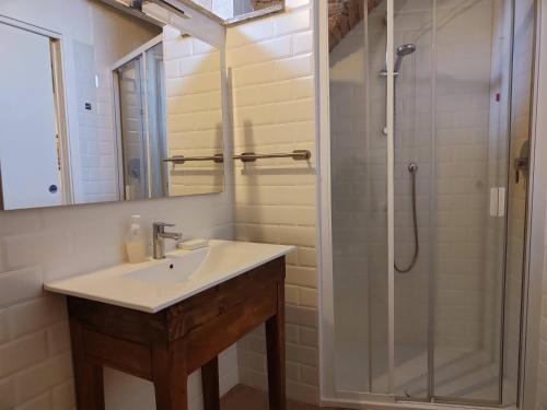 a bathroom with a sink and a shower at Dimora Porta Venere in Spello