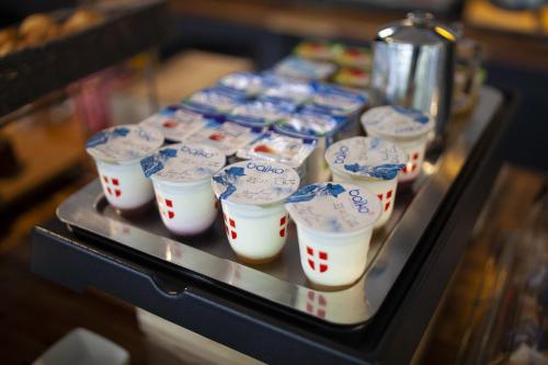 a tray filled with cups of food on a table at Sure Hotel by Best Western Lille Tourcoing Ex Hotel Garden in Bondues