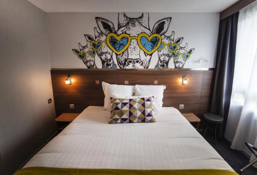 a hotel room with a bed with hearts on the wall at Sure Hotel by Best Western Lille Tourcoing Ex Hotel Garden in Bondues