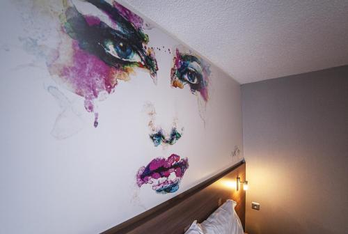 a painting on the wall of a hotel room at Sure Hotel by Best Western Lille Tourcoing Ex Hotel Garden in Bondues