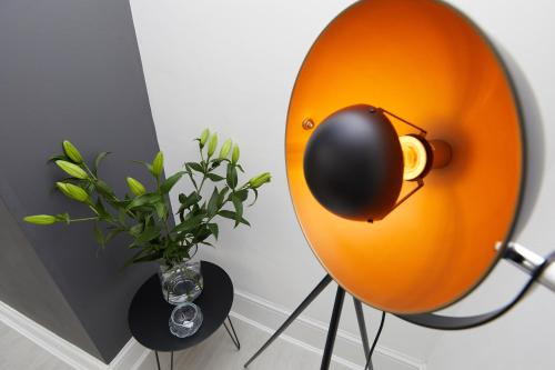 a yellow orb with a vase with a plant in a room at Your Sheffield Stays - Spacious 5 Bedroom House in Sheffield