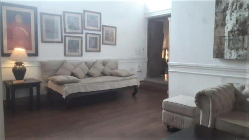 a living room with a couch and a chair at The Rajbari Bawali in Kolkata