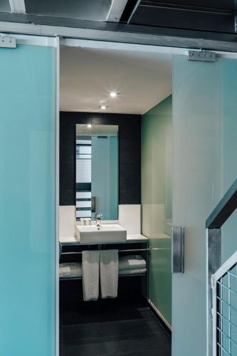 a bathroom with a sink and a mirror at Barcelona Apartment Republica in Barcelona