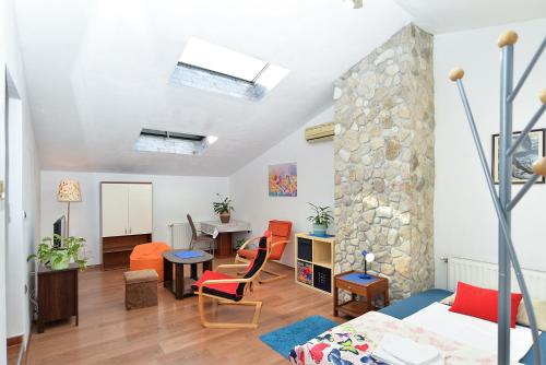 a living room with a stone wall at Apartment Puzar 295 in Štinjan