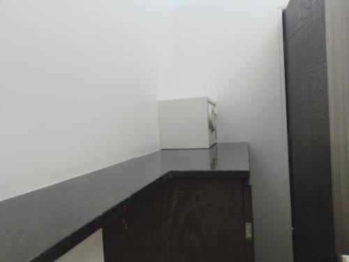 a shelf in a room with a white wall at Hotel Udayanraje Palace in Ahmadnagar