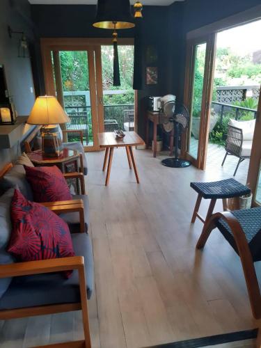 a living room with a couch and a table at The Lantern Suites in Ban Song Hong