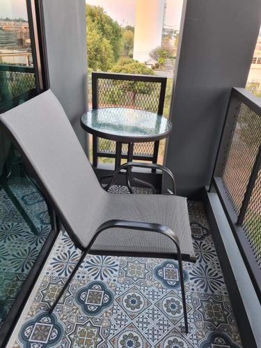 a balcony with a table and a table and chairs at The Lantern Suites in Ban Song Hong