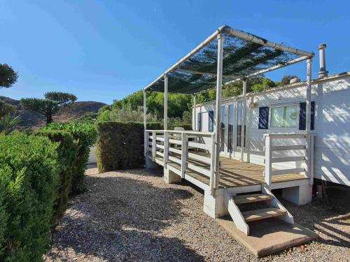 a mobile home with a porch and a staircase at Centro Vacacional Macenas in Mojácar