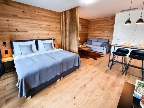 a bedroom with a bed and a desk and a couch at Tee House Čeladná in Čeladná
