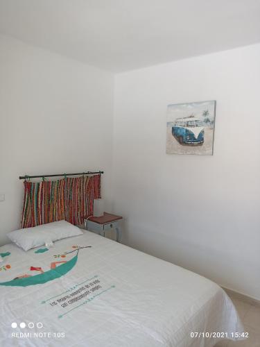 a bedroom with a bed with a sign on it at Apartamentos El Carmen in Morro del Jable