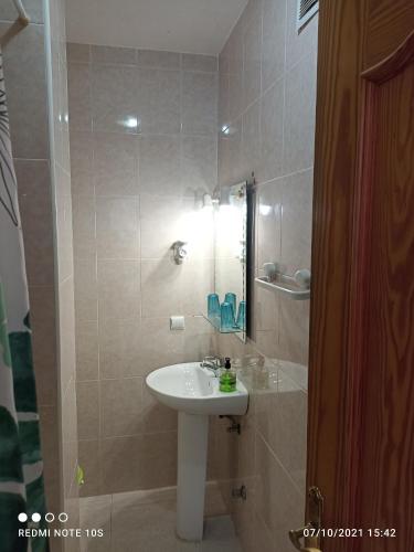 a bathroom with a sink and a mirror at Apartamentos El Carmen in Morro del Jable