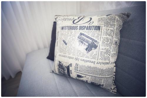 a newspaper pillow sitting on top of a bed at סוויטת אדל in Bet Sheʼan