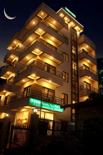 a large building with a sign in front of it at night at Hotel Family Ties Pvt. Ltd. in Kathmandu