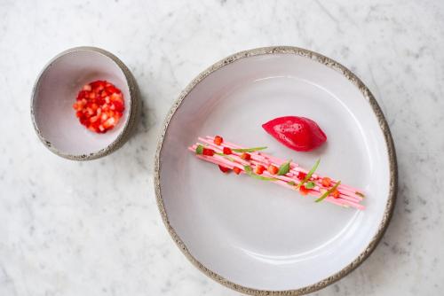 a white plate with some pink food on it at Sezz Saint-Tropez in Saint-Tropez