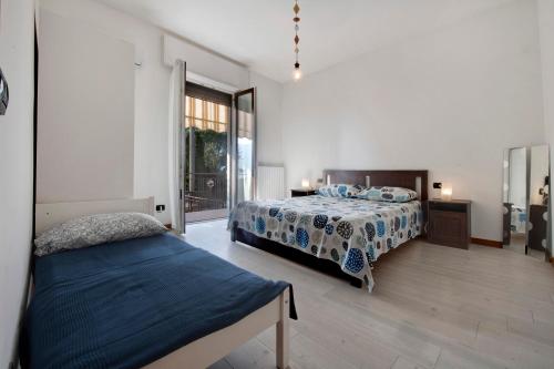 a bedroom with a bed and a large window at Sibi Apartment in Lierna