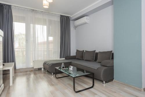 a living room with a couch and a table at Downtown Accommodation in Bucharest